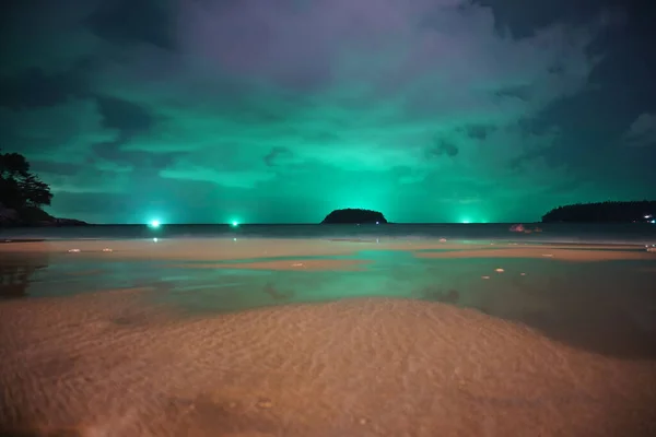 Unusual green illumination of the sky on island — стоковое фото