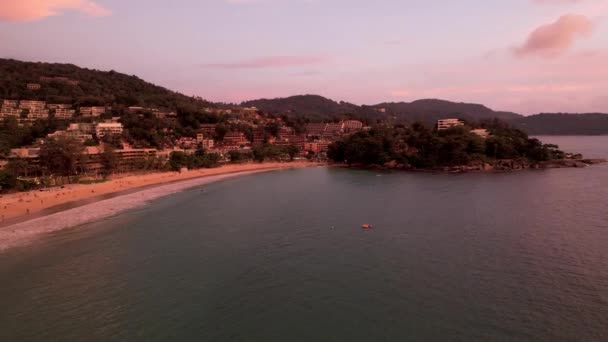 Aerial view of the island at sunset from a drone. — ストック動画