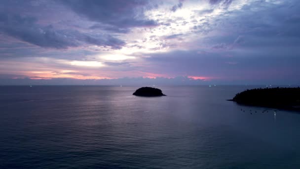 Fioletowy zachód słońca z widokiem na morze i chmury. — Wideo stockowe