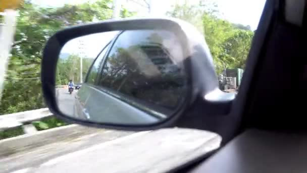 View of the side mirror of car. Left-hand traffic — стоковое видео