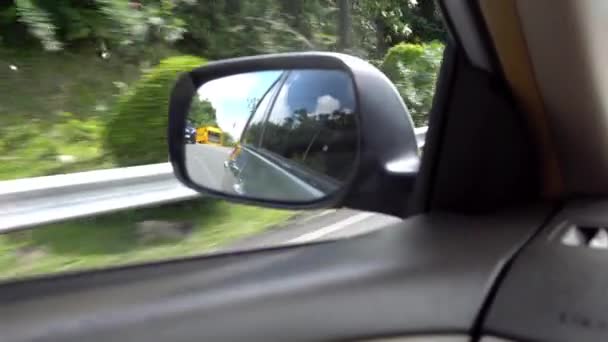 View of the side mirror of car. Left-hand traffic — Wideo stockowe