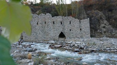 View of green grasses and stone fortress