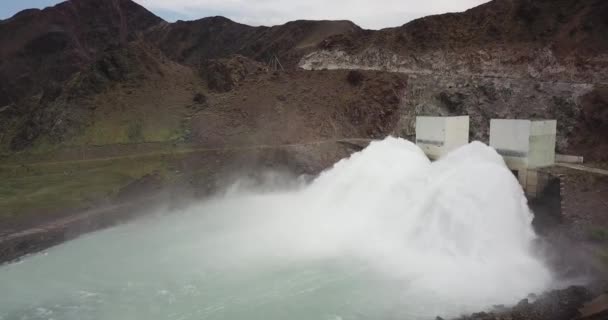 水の大規模な放電圧力を持つダム ダムだ ドローンでの撮影 巨大な水の圧力 大きな噴水だ 噴水の周りに草 川を実行して成長します 夏の自然 小さな岩 — ストック動画