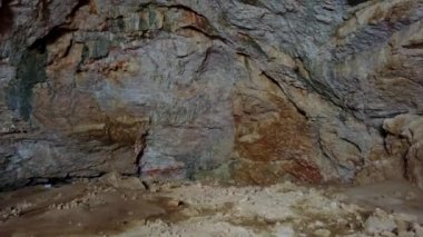 The sacred cave of the white mosque. A huge cave with its own eco-climate. It is snowing on the surface, and a large tunnel hole is visible. Inside the cave there are trees and heat. The birds fly.