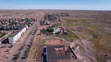 The small town of Balkhash is a view from a drone. There are new and old houses, playgrounds are being built. Cars are driving on the roads. A city in the middle of the steppe, but next to a lake