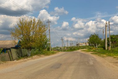Gagauzja, Moldova Cumhuriyeti - 02 Mayıs 2016: çayırlar ve tarlalar arasında çakıl yolu. Bahar mevsimi kırsal alan.