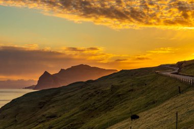 Faroe Adaları üzerinde gün batımı, Atlantik Okyanusu 'nda volkanik bir takımada. Vagar Adası, Faroe Adaları 'ndan..