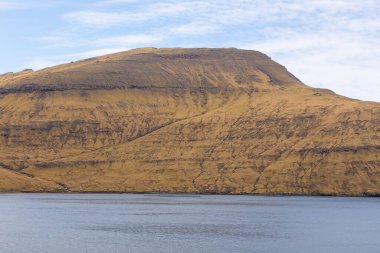 Vagar Adası 'ndaki Bour yakınlarındaki sahil manzarası. Devasa uçurumlar, uçurumlar ve okyanus manzarası. Vagar Adası 'nda bir otobüs. Faroe Adaları.