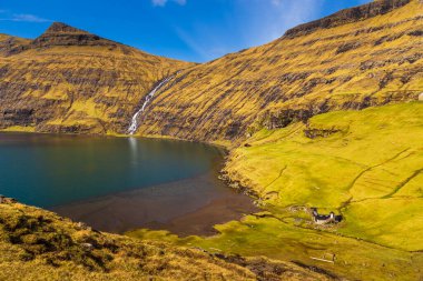 Güzel bir bahar manzarası. Tipik çim-üstü evleri ve Faroe Adaları 'ndaki Pollurin Gölü manzaralı Saksun köyü manzarası. Streymoy Adası, Danimarka, Avrupa 'nın muhteşem manzarası.