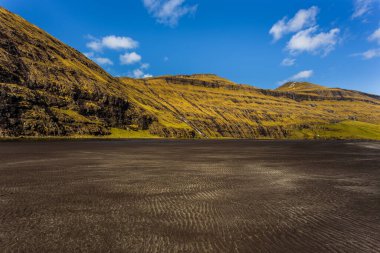 Osin Körfezi 'ndeki karanlık sahil ve dik dağ yamaçları. Saksun köyünü Atlantik Okyanusu 'na bağlayan bir körfez. Saksun, Faroe Adaları, Danimarka.