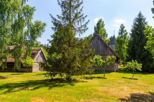 Thatched cottage among the trees of the garden in open-air museum, Kashubian Ethnographic Park. Wdzydze Kiszewskie, Poland.