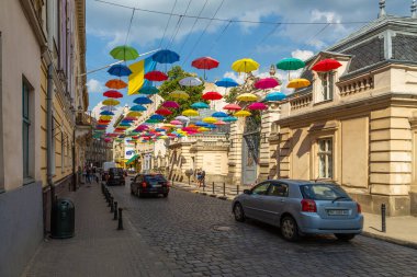 Lviv, Ukraine - 08 June 2018: Colorful umbrellas in the streets. Art object in old city of Lviv. Pedestrian street with bright decoration. Variety of multicolored umbrellas. Lviv cityscape