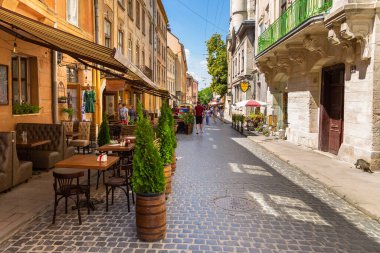 Lviv, Ukraine - 08 June 2018: Traditional buildings in a cobblestone street in historical Old town of Lviv.