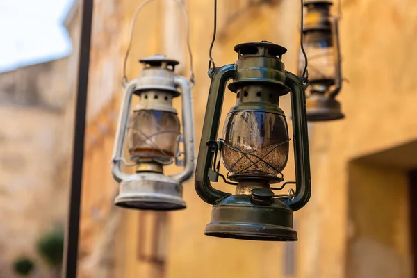 Decorative lamps in the style of old kerosene lamps on the background of a historical tenement house. Architecture of Lviv. City center. Ukraine.