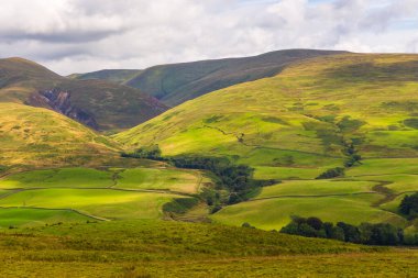 View of the green hills in Dumfries and Galloway. Rural landscape, north UK.