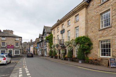 Kirkby Lonsdale, Cumbria, England - 12 August 2018: Narrow streets in the village. Traditional stone and white houses.