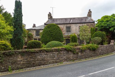 Kirkby Lonsdale, Cumbria, England - 12 August 2018: Narrow streets in the market town. Traditional stone and white houses.