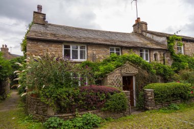 Dent, Cumbria, UK -12 August 2018: Facade of a stone building in the village of Dent in the Yorkshire Dales, Dent, UK