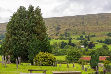 Dent, Cumbria, England, UK - 12 August 2018: Cemetery at the Saint Andrew Church, active Anglican parish church. The church contains Norman architecture.