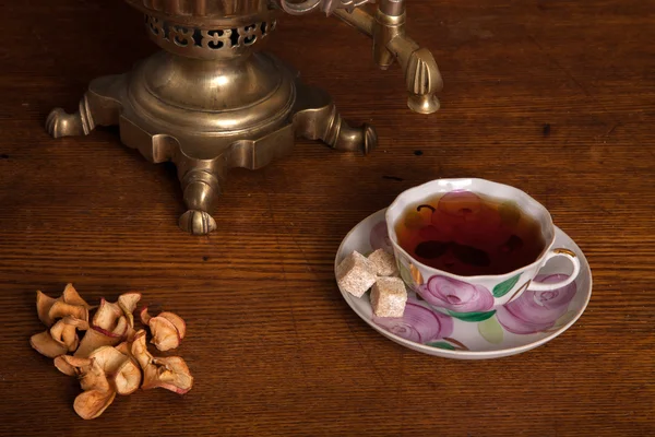 Samovar and a cup with tea — Stock Photo, Image