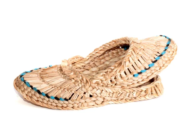 Old Russian sandals made of bark on the white background — Stock Photo, Image