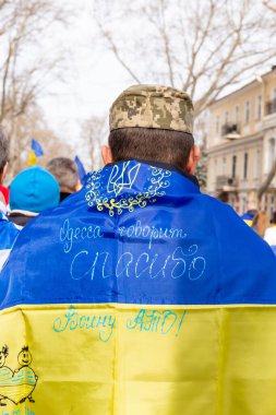 ODESSA, UKRAINE - 20 FEB 2022: Unity march in Odessa against Russian invasion. Sign on flag 