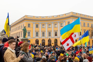 ODESSA, UKRAINE - 20 FEB 2022: Unity march in Odessa against Russian invasion. Crowd of people with flags, concept of patriotism. clipart