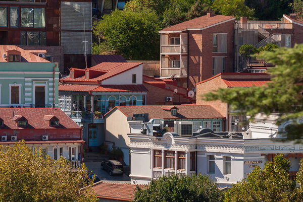 Georgia, Tbilisi - September 25, 2022: Houses with balconies in the historic district of Tbilisi. Georgia. Evening View. Beautiful Old town at sunset.