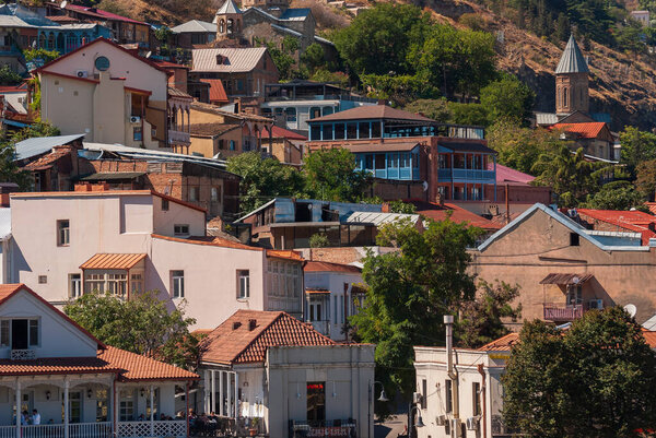 Georgia, Tbilisi - September 25, 2022: Houses with balconies in the historic district of Tbilisi. Georgia. Evening View. Beautiful Old town at sunset.