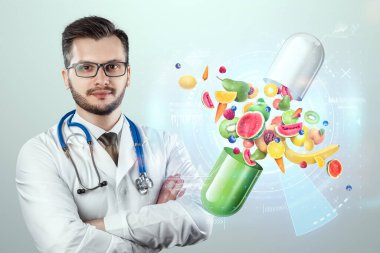 Doktorun arka planında meyve ve vitamin içeren tıbbi kapsüller şeklinde gıda takviyesi. Doğru diyet, diyet, alternatif tıp, vitaminler, naturopati, homeopati.