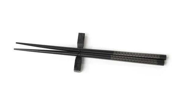 Two black chopsticks isolated — Stock Photo, Image