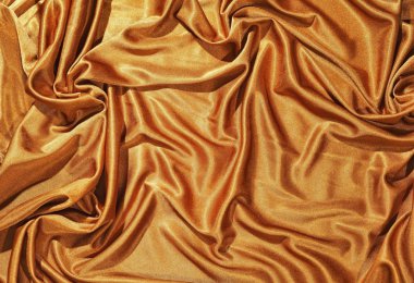 Texture of the glden cloth with folds clipart