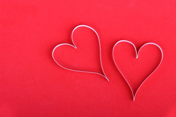 Valentine 's paper hearts on the red — стоковое фото