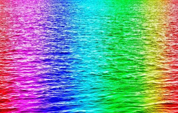 Rainbow colored water waves in ocean — Stock Photo, Image