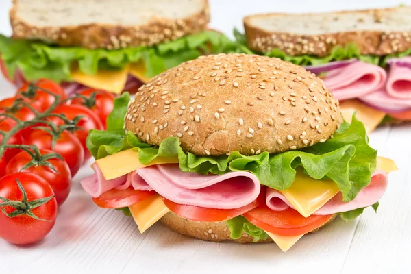 Булочка і бутерброди з сиром шинки — стокове фото