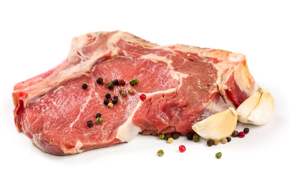 Rohes Rindfleisch mit weißem Knoblauch Hintergrund — Stockfoto