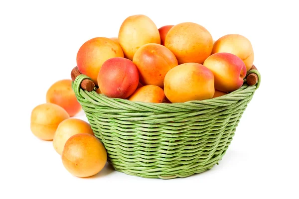 Ripe apricots in a wicker basket — Stock Photo, Image