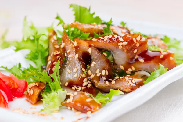 Smoked eel with unagi sauce and sesame seeds — Stock Photo, Image