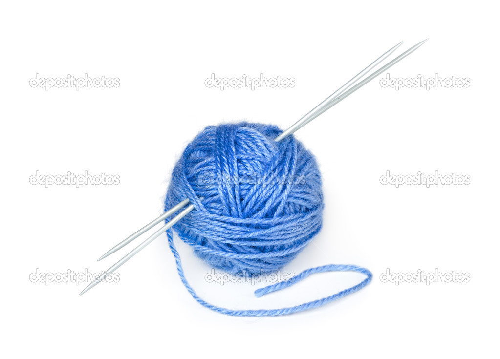 Clew of wool yarn with knitting needles  