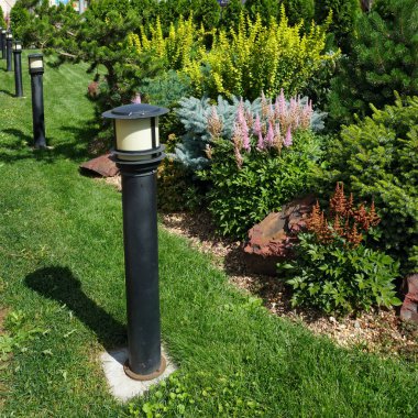 Garden lamp on a green grass clipart