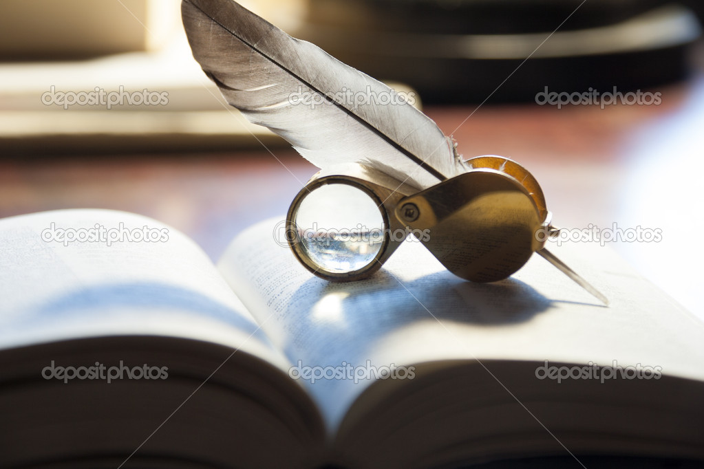open book and quill pen