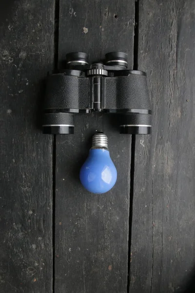 Creative Background Binoculars Blue Light Bulb High Quality Photo —  Fotos de Stock