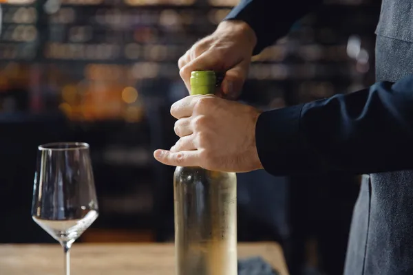 Sommelier的袖手用瓶塞螺丝打开一瓶白葡萄酒的瓶塞 — 图库照片