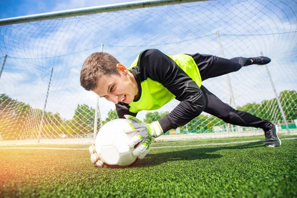 Action Soccer man player goalkeeper catching ball at penalty