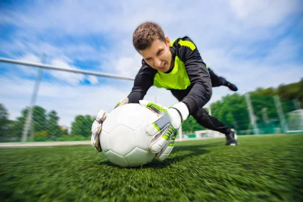 Goalkeeper soccer man catching ball action sport moment