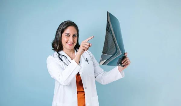 在墨西哥 他的惊慌失措的女医生在蓝色背景的放射科诊所里查看X射线影像 — 图库照片