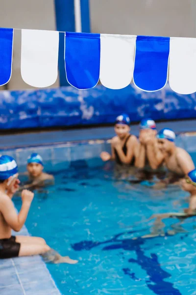 public swimming pool with team of people in competition or training at background in Latin America