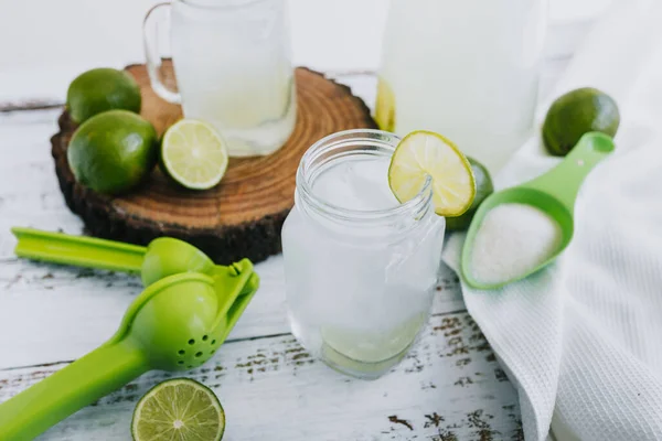 Jar Glass Lemonade Drink Green Lemons Lime White Background Latin — стоковое фото