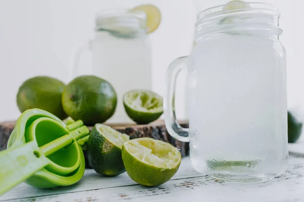 Jar Glass Lemonade Drink Green Lemons Lime White Background Latin — стоковое фото