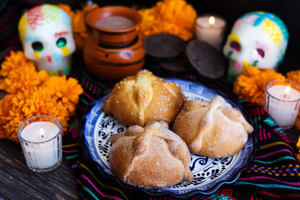 Mexican bread on Altar with sugar skull and hot chocolate traditional food for Celebration of Mexico's Day of the Dead